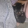 kitten, cat, person, blanket, snuggling, cozy, furry, resting, indoors, soft_texture, tabby, comfort, sleeping, close_up, warm, feline, pet, companion, relaxation, home