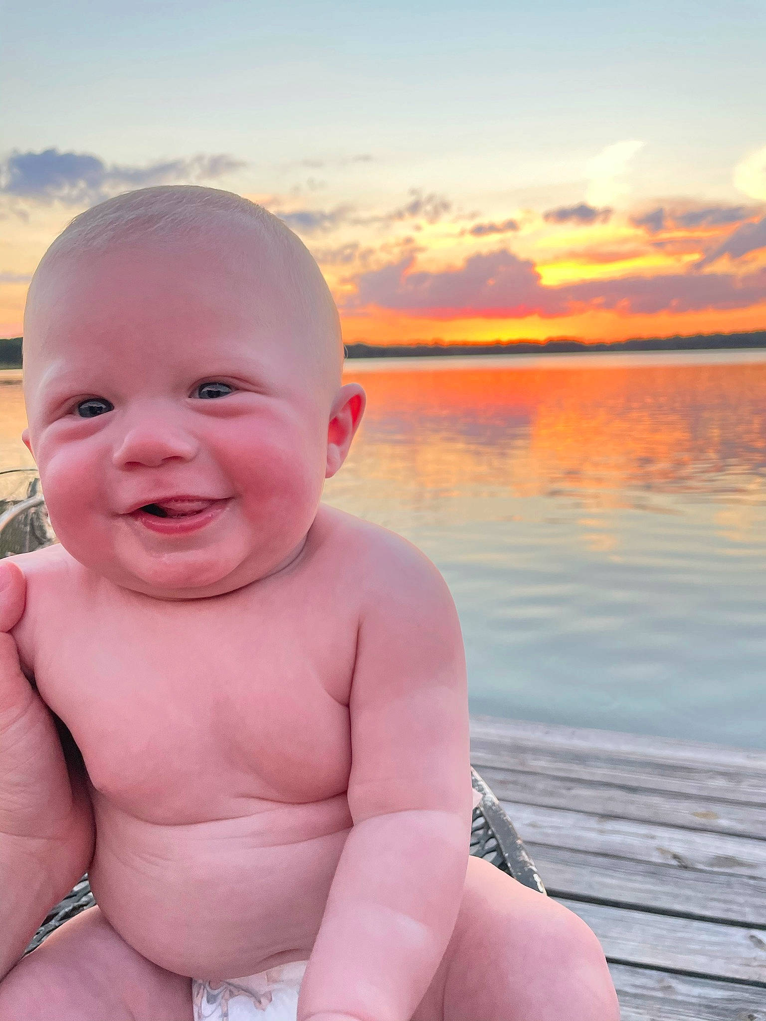 Eli is registered to the contest to win money with this photo: baby, chest, child, cloud, flash_photography, fun, gesture, happy, horizon, human_body, joy, lake, leisure, people_in_nature, person, sitting, skin, sky, smile, summer