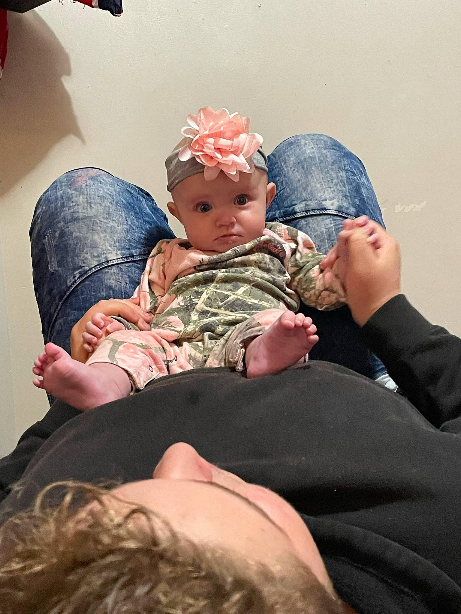 Haylee is registered to the contest to win money with this photo: baby, cap, child, comfort, costume, couch, event, finger, fun, gesture, happy, hat, headwear, human_body, interaction, lap, mammal, mouth, person, sitting
