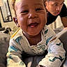 Khylo joined the competition — help win amazing prizes! baby, child, dinosaur_pajamas, smiling, happy, indoor, person, young_man, bedroom, blanket, pajamas, face, closeup, portrait, curly_hair, furniture, human, expression, infant, candid