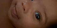 Evelynn is registered to the contest to win money with this photo: baby, face, tongue, eyes, infant, skin, cute, closeup, child, lying_down, blanket, soft, expression, portrait, indoors, person, head, newborn, cheeks, curious