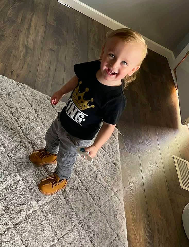 Elijah is registered to the contest to win money with this photo: denim, elbow, flash_photography, floor, flooring, fun, hardwood, human_leg, joy, knee, leisure, person, recreation, room, sandal, sitting, sleeve, sneakers, t_shirt, tints_and_shades