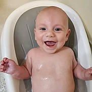 Dawson is registered to the contest to win money with this photo: baby, bathtub, water, smile, happy, child, infant, skin, bubbles, bath, cute, chubby, face, head, arm, torso, clean, wash, young, joy