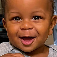 Luca joined the competition — help win amazing prizes! baby, toddler, smile, happy, face, child, toy, hand, indoor, curly_hair, clothing, person, closeup, play, joy, expression, cute, young, skin, eyes