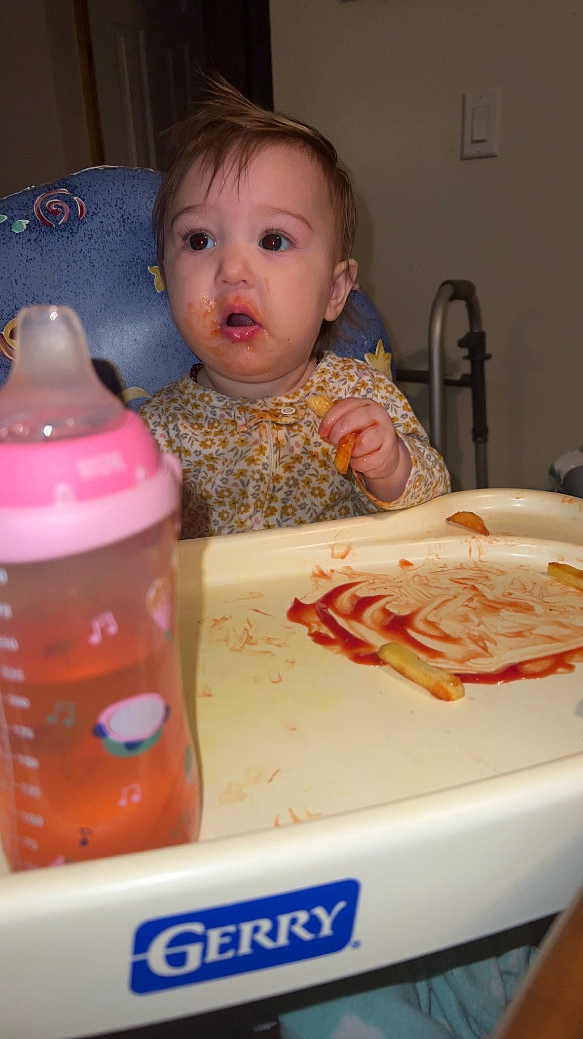 Elora is registered to the contest to win money with this photo: baby, baby_toddler_clothing, bottle, cheek, child, comfort_food, cuisine, dish, dishware, drink, drinkware, food, ingredient, junk_food, person, plastic, plastic_bottle, surprise, sweetness, tableware