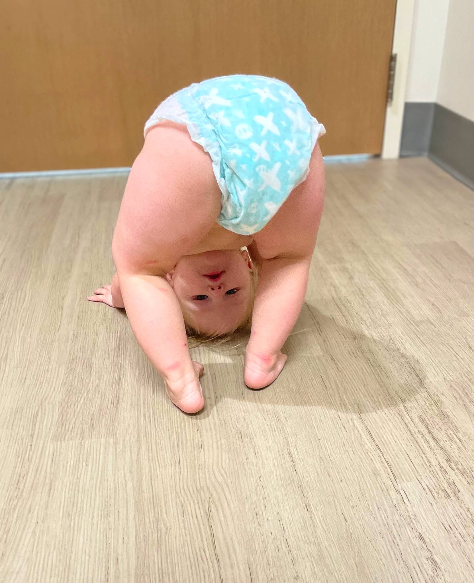 Brilee is registered to the contest to win money with this photo: baby, baby_toddler_clothing, barefoot, comfort, crawling, flooring, foot, happy, hardwood, head, human_leg, knee, laminate_flooring, person, thigh, thumb, toddler, toe, wood, wood_flooring