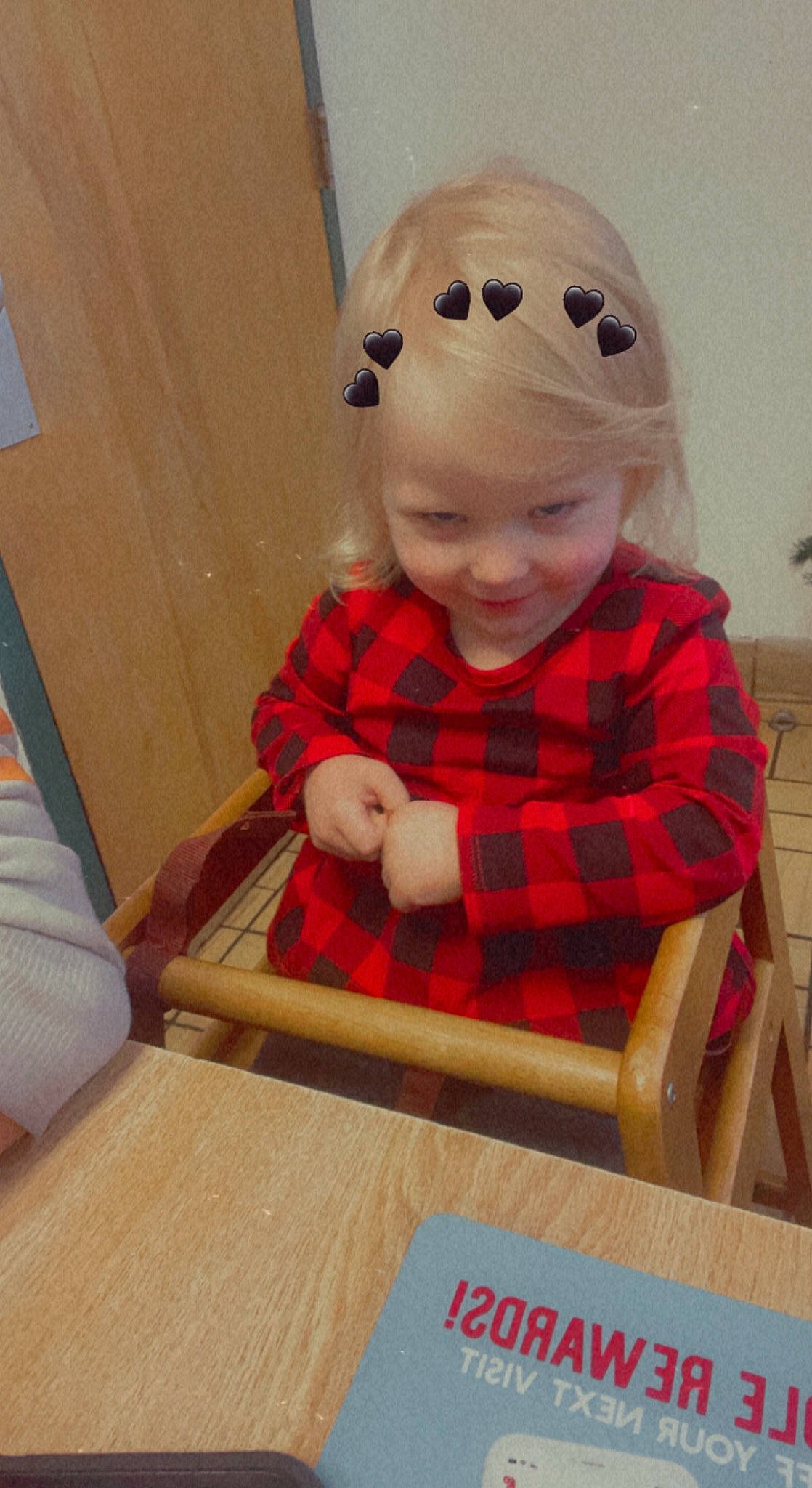 Brilee joined the competition — help win amazing prizes! baby_toddler_clothing, child, floor, flooring, fun, happy, hardwood, headwear, outerwear, pattern, person, personal_protective_equipment, plaid, sitting, sleeve, smile, t_shirt, table, tartan, toddler
