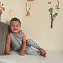 Eduard is registered to the contest to win money with this photo: child, smiling, bed, pajamas, tank_top, striped_clothing, wall_decals, giraffe, monkey, elephant, zebra, jungle_theme, animal_stickers, indoor, happy, young_child, barefoot, furniture, playful, cozy