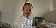Eduard joined the competition — help win amazing prizes! child, boy, smiling, pajamas, bed, plush_toy, teddy_bear, wall_decals, animal, indoors, happy, cute, person, furniture, bedroom, casual_clothing, sitting, foot, white_shirt, blue_pants