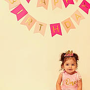 Camilla joined the competition — help win amazing prizes! toddler, girl, birthday, crown, pink_dress, one_year_old, celebration, happy_birthday_banner, smiling, sitting, cute, child, portrait, indoor, party, young_child, festive, pigtails, gold_text, soft_lighting