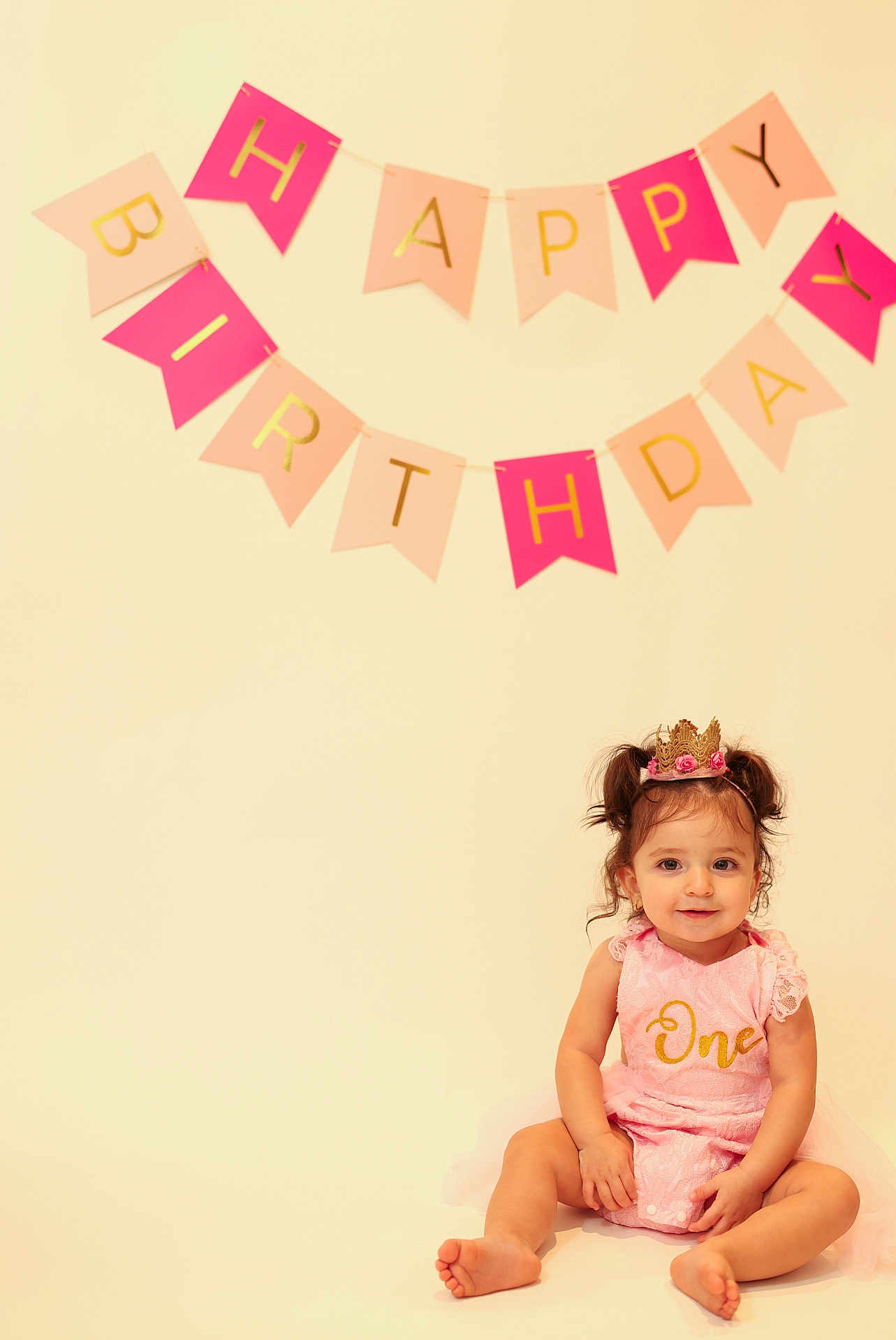 Camilla joined the competition — help win amazing prizes! toddler, girl, birthday, crown, pink_dress, one_year_old, celebration, happy_birthday_banner, smiling, sitting, cute, child, portrait, indoor, party, young_child, festive, pigtails, gold_text, soft_lighting