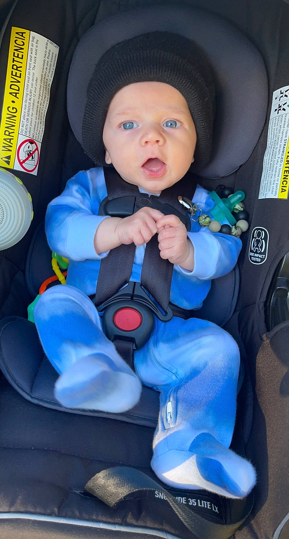 Lincoln is registered to the contest to win money with this photo: auto_part, baby, baby_carriage, baby_in_car_seat, baby_products, baby_safety, baby_toddler_clothing, car_seat, car_seat_cover, carmine, child, comfort, electric_blue, fun, headwear, person, product, sitting, smile, steering_wheel