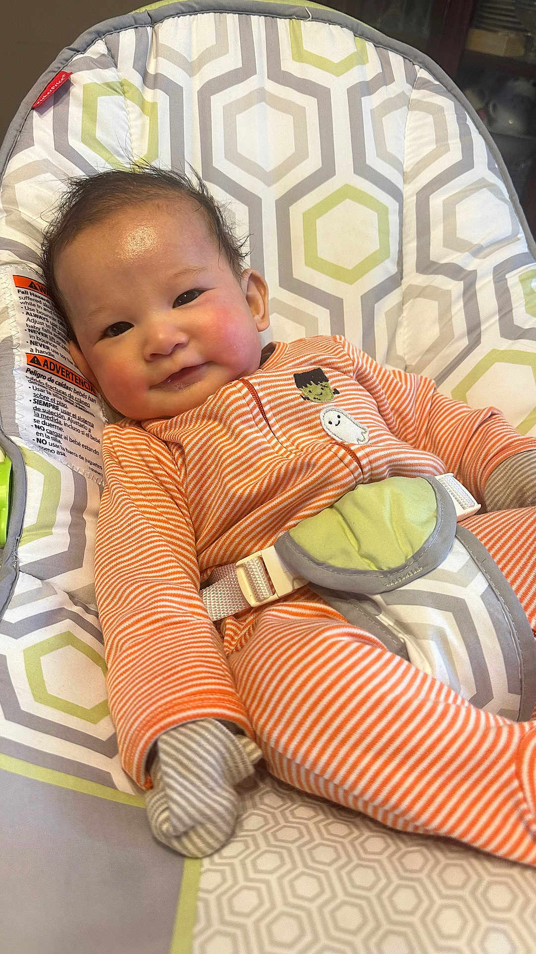 Joseph G joined the competition — help win amazing prizes! baby, baby_chair, child, cozy, cute, face, gloves, happy, head, human, indoor, infant, onesie, orange_clothing, patterned_fabric, seatbelt, smiling, striped_clothing, toddler, young