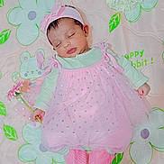 Tejasvini Anish is registered to the contest to win money with this photo: baby, sleeping, pink_dress, headband, flower, blanket, floral_pattern, soft_toys, cute, infant, peaceful, indoors, child, newborn, laying_down, pink_booties, white_flowers, tulle, toddler, pastel_colors