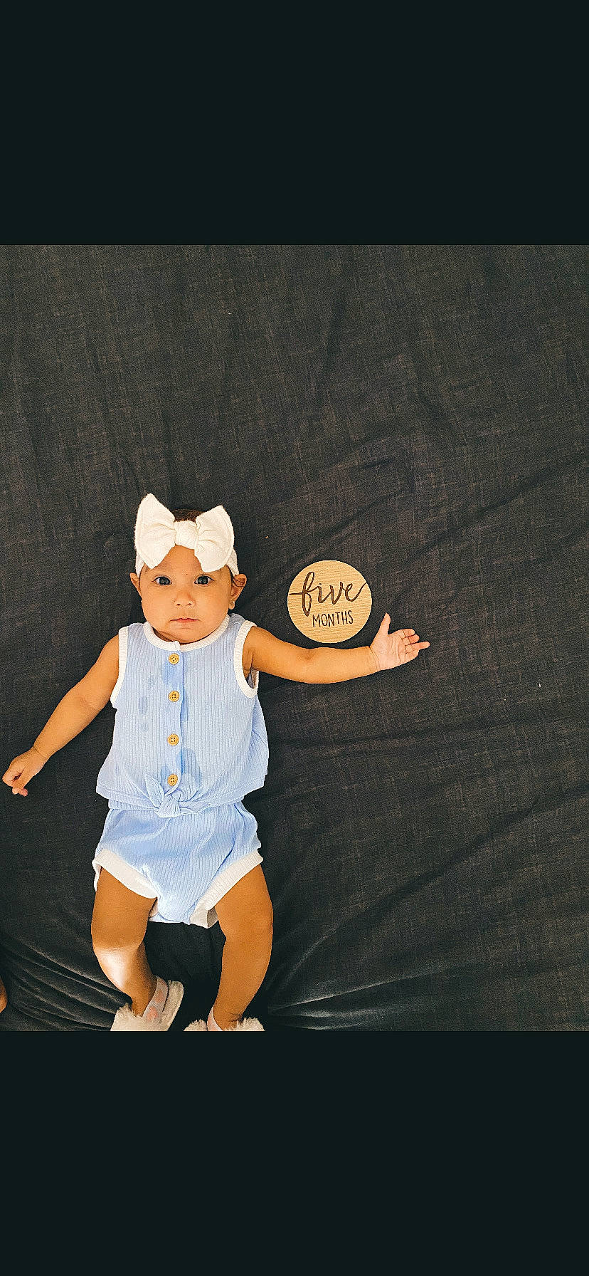 Janaya joined the competition — help win amazing prizes! arm, baby, baby_toddler_clothing, ball, flash_photography, font, gesture, hand, happy, hat, headwear, human_body, human_leg, person, shirt, shorts, sitting, sleeve, sportswear, t_shirt
