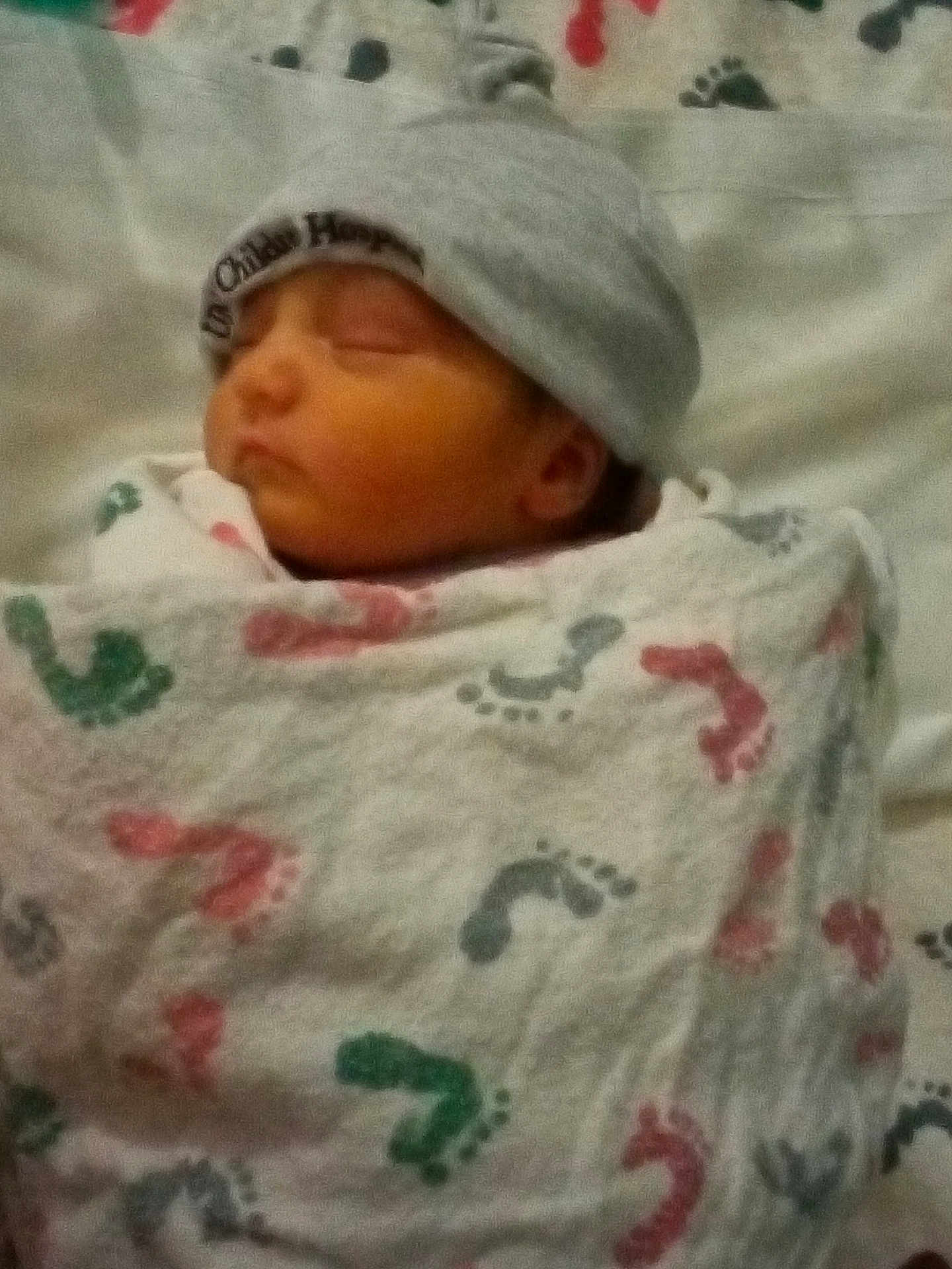 Sariyah joined the competition — help win amazing prizes! architecture, baby, bed, blanket, bonnet, building, cap, clothing, face, furniture, hat, head, hospital, newborn, person, photography, portrait, quilt, sleeping, towel