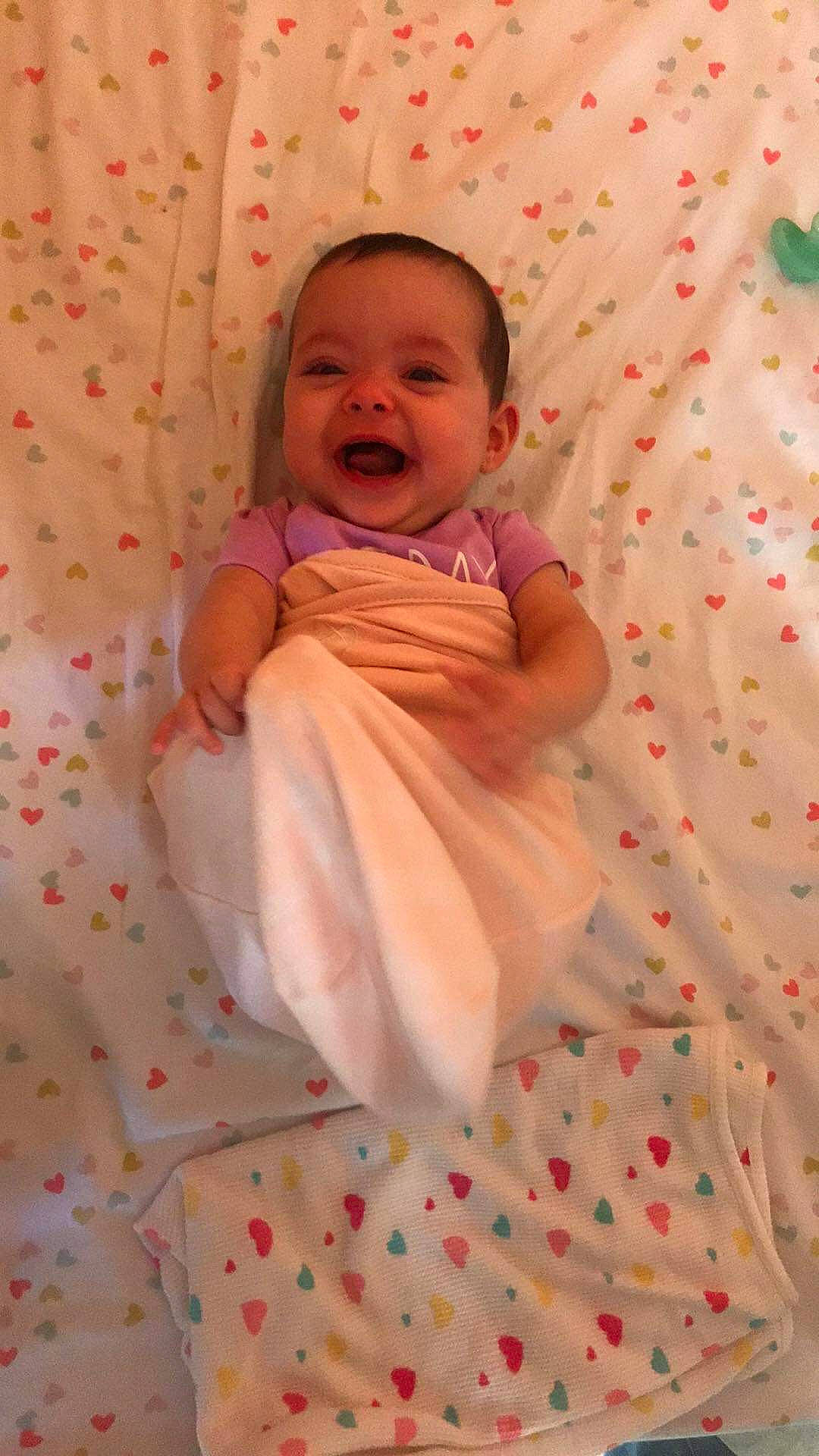 Fray is registered to the contest to win money with this photo: baby, cheek, child, linens, person, pink, skin, smile, textile, toddler