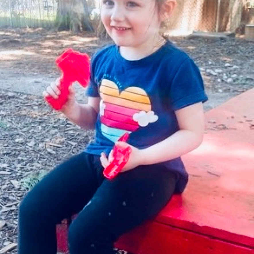 Athena is registered to the contest to win money with this photo: backyard, child, clothing, face, female, girl, grass, head, jeans, nature, outdoors, pants, person, photography, plant, portrait, sitting, summer, tree, yard