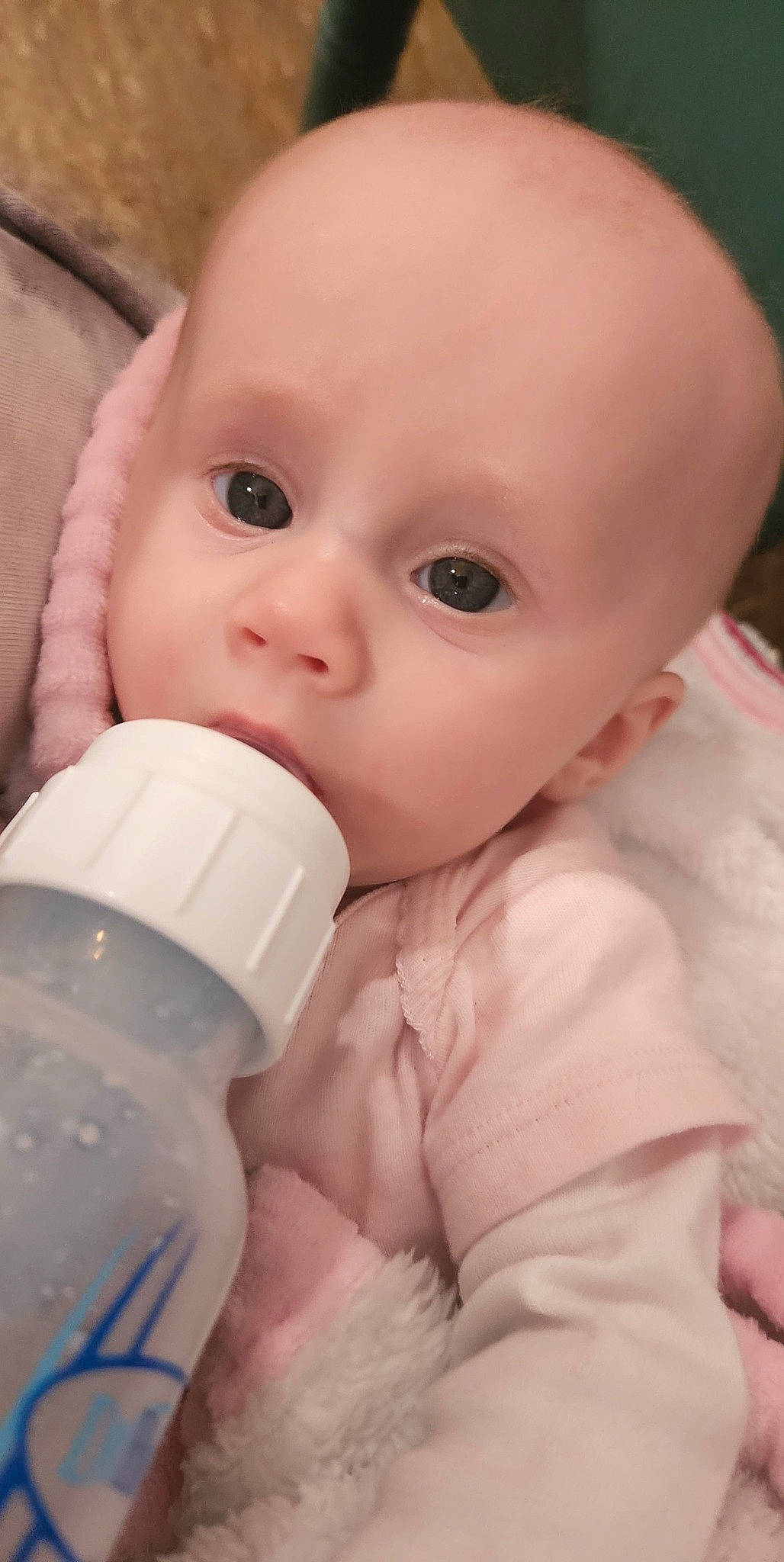 Maddilyn is registered to the contest to win money with this photo: baby, baby_bottle, bottle, cheek, drinkware, ear, eye, eyebrow, eyelash, face, facial_expression, gesture, head, human_body, iris, lip, mouth, nose, person, plastic_bottle