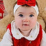 baby, child, headband, red_bow, red_vest, white_shirt, teddy_bear, toy, cute, portrait, indoor, smile, face, eyes, head, soft_toy, infant, apparel, closeup, adorable