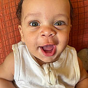 Josiah Harrison joined the competition — help win amazing prizes! baby, baby_clothes, child, closeup, clothing, cushion, cute, expression, eyes, face, happy, indoor, infant, person, portrait, sitting, skin, small_hands, smile, young_child