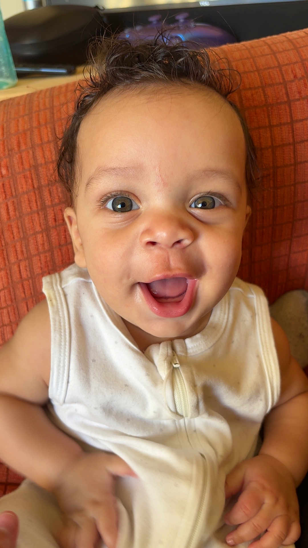 Josiah Harrison joined the competition — help win amazing prizes! baby, baby_clothes, child, closeup, clothing, cushion, cute, expression, eyes, face, happy, indoor, infant, person, portrait, sitting, skin, small_hands, smile, young_child