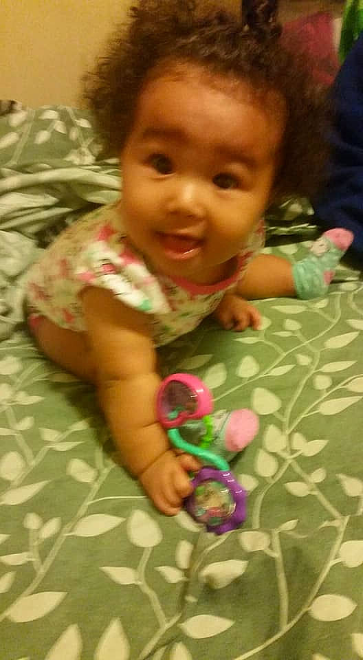 Mu'Lan is registered to the contest to win money with this photo: arm, cheek, child, day, eye, finger, fun, girl, head, infant, iris, person, play, skin, toddler