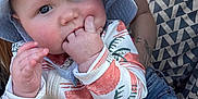 Bowen is registered to the contest to win money with this photo: baby, child, hat, sun_hat, onesie, hand, fingers, person, nail_polish, tattoo, lap, patterned_fabric, geometric_pattern, outdoor, cute, infant, skin, face, blue_eyes, pink_nails