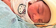Emirett is registered to the contest to win money with this photo: baby, bed, blanket, child, cozy, cute, fabric, hat, hello_kitty, infant, nap, newborn, onesie, pattern, peaceful, person, rest, skin, sleeping, soft