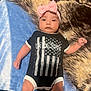 Emirett is registered to the contest to win money with this photo: baby, infant, onesie, headband, bow, blanket, pattern, flag, american_flag, text, lying_down, cute, skin, hands, legs, portrait, clothing, indoor, young_child, face