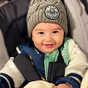 Alejandro participe au concours pour gagner de l'argent avec cette photo : baby, blanket, bundle, child, clothing, cozy, cute, face, hand, happy, hat, indoors, infant, jacket, knit_hat, pom_pom, portrait, smiling, stroller, warm