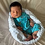 baby, newborn, sleeping, blanket, onesie, blue_clothing, space_print, bed, soft_texture, infant, peaceful, wrapped, resting, cute, small_hands, small_feet, indoors, portrait, cozy, child