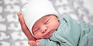 Liam participe au concours pour gagner de l'argent avec cette photo : baby, beanie, blanket, bodypart, bonnet, cap, clothing, face, finger, hand, hat, head, newborn, person, photography, portrait, sleeping