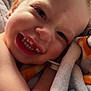 Carter is registered to the contest to win money with this photo: toddler, child, smile, teeth, blanket, close_up, face, happy, cozy, soft_texture, indoor, skin, expression, cute, young_child, snuggle, comfort, warm, person, infant