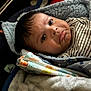 Brashaun joined the competition — help win amazing prizes! baby, blanket, face, person, infant, closeup, expression, soft, cozy, wrapped, clothing, striped, cute, child, indoors, texture, warm, comfort, head, portrait