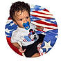 toddler, child, pacifier, curly_hair, mickey_mouse, shirt, socks, blanket, american_flag, red, white, blue, indoor, portrait, cute, baby, clothing, pattern, person, sitting