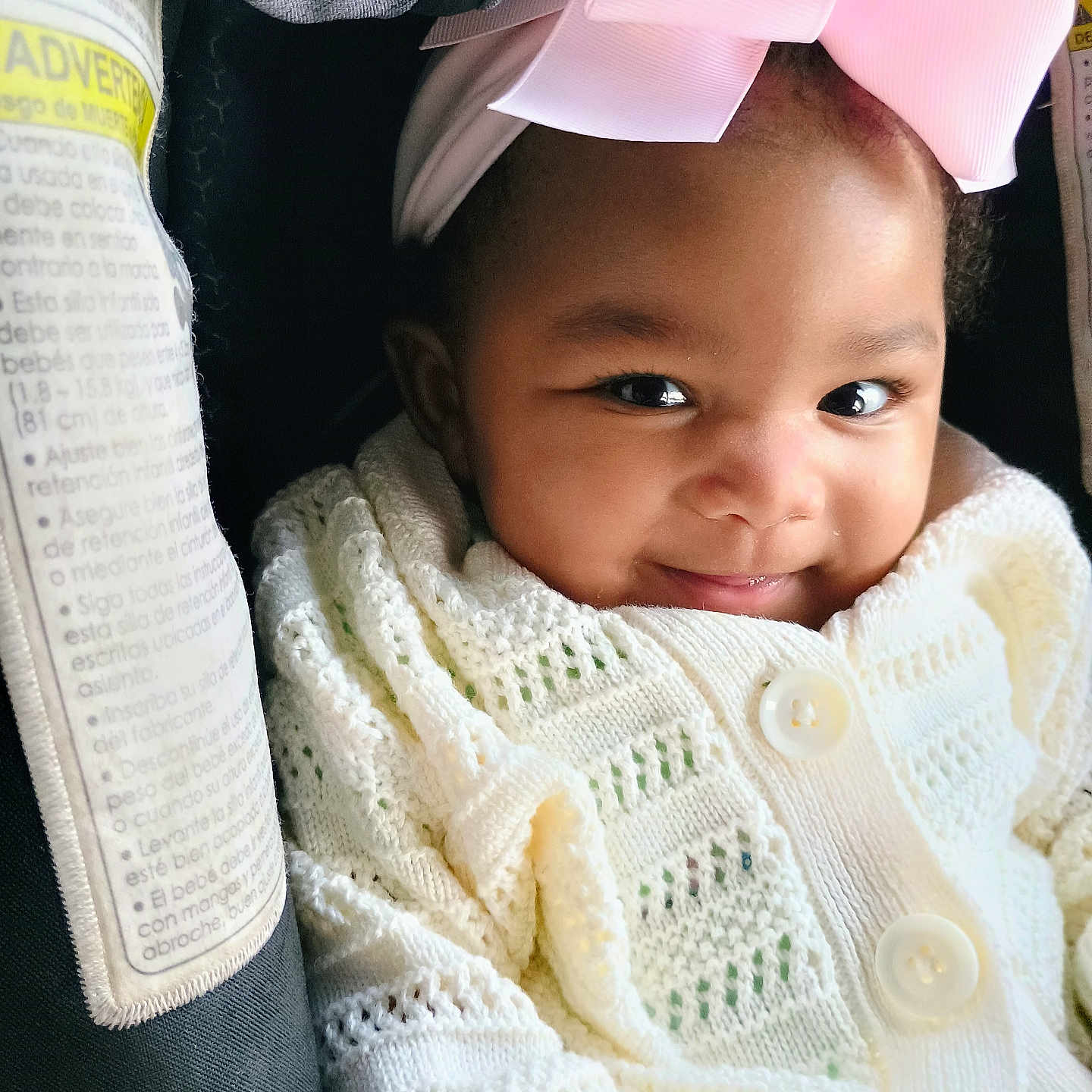 Zariya joined the competition — help win amazing prizes! baby, baby_girl, car_seat, child, closeup, clothing, cute, face, happy, headband, indoors, infant, knitted, person, pink_bow, portrait, seatbelt, smiling, white_sweater, young_child