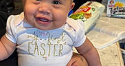 Naomi joined the competition — help win amazing prizes! baby, child, smile, bow, headband, easter, tutu, socks, indoor, kitchen, table, person, holding, happy, cute, clothing, infant, celebration, family, portrait