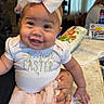 baby, child, smile, bow, headband, easter, tutu, socks, indoor, kitchen, table, person, holding, happy, cute, clothing, infant, celebration, family, portrait