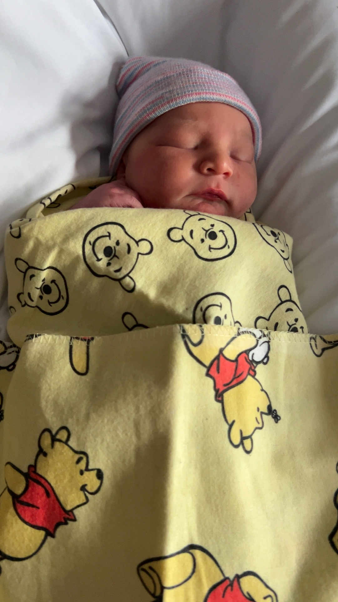 Maddox is registered to the contest to win money with this photo: newborn, baby, sleeping, blanket, winnie_the_pooh, hat, bed, white, soft, cute, infant, child, wrapped, peaceful, portrait, indoors, clothing, rest, comfort, hospital
