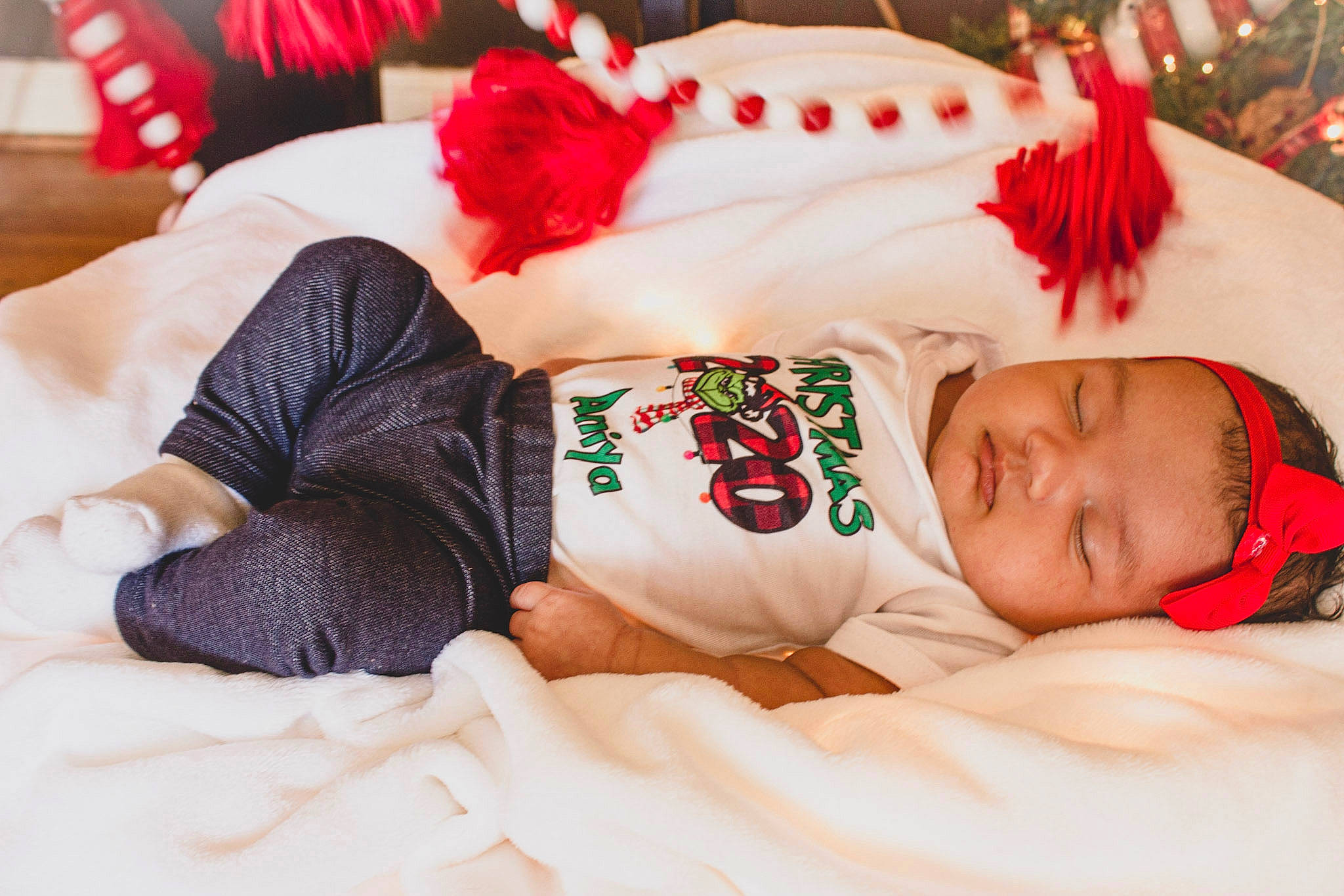 Aniya is registered to the contest to win money with this photo: baby, baby_sleeping, baby_toddler_clothing, bed, bedding, bedtime, blanket, child, christmas, christmas_eve, comfort, costume_accessory, holiday, human, linens, nap, person, red, sleep, textile