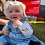 baby, child, smiling, hat, denim_overalls, outdoor, grass, person, happy, cute, sunhat, playful, blue_eyes, casual_clothing, infant, nature, daylight, portrait, sitting, baby_girl
