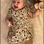 Mhiran is registered to the contest to win money with this photo: baby, smiling, floral_dress, headband, plush_toy, blanket, lying_down, cute, child, infant, happy, indoors, soft_toy, patterned_clothing, person, portrait, baby_girl, cozy, playful, young_child
