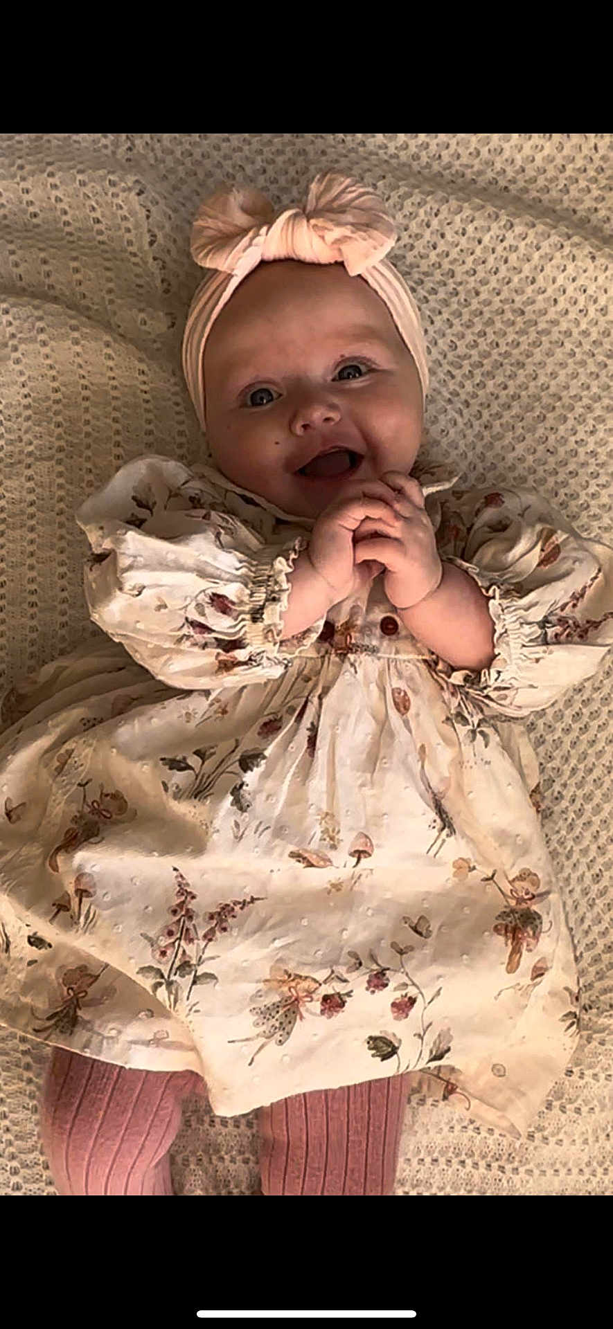 Mhiran joined the competition — help win amazing prizes! baby, smiling, headband, bow, floral_dress, pink_tights, knitted_blanket, happy, cute, infant, child, portrait, clothing, hands, lying_down, indoors, soft_lighting, face, person, toddler