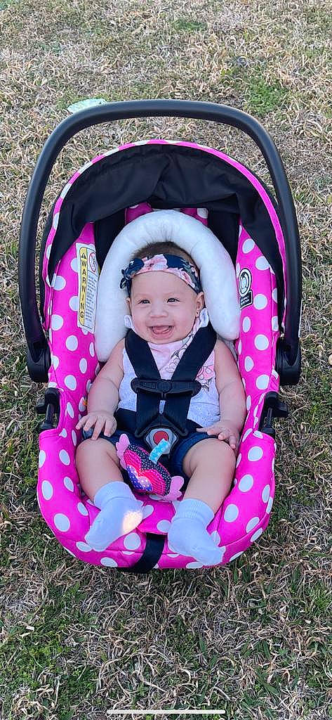 Kyomi is registered to the contest to win money with this photo: baby, baby_carriage, baby_products, baby_toddler_clothing, black, comfort, cool, eye, facial_expression, fun, grass, happy, headwear, joy, leaf, leisure, magenta, people_in_nature, person, pink