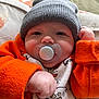 Matthew joined the competition — help win amazing prizes! baby, pacifier, beanie, orange_jacket, blanket, infant, cute, chubby_cheeks, sleepwear, cozy, hand, face, portrait, child, clothing, pattern, lying_down, soft_texture, indoor, cute_expression