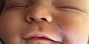 Matthew is registered to the contest to win money with this photo: baby, close_up, sleeping, smile, face, infant, child, peaceful, cute, skin, newborn, portrait, soft_light, cozy, clothing, hand, relaxation, indoors, calm, adorable