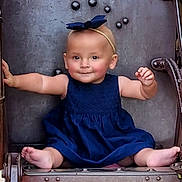 Arrow is registered to the contest to win money with this photo: baby, child, girl, dress, headband, blue_dress, smile, sitting, barefoot, metal, rust, industrial, holding, outdoor, cute, infant, portrait, playful, young_child, person