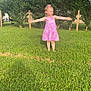 arms_outstretched, casual, child, daylight, fence, girl, grass, greenery, happy, nature, outdoor, person, pink_dress, playful, smile, standing, summer, sunlight, tree, yard