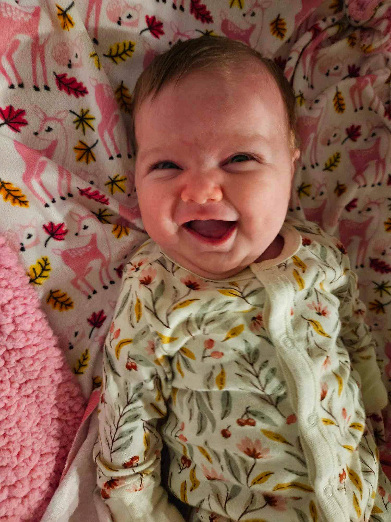 Eleanor is registered to the contest to win money with this photo: baby, baby_laughing, baby_toddler_clothing, bedding, cheek, child, comfort, fun, happy, linens, pattern, people, person, pink, product, room, skin, sleeve, smile, textile